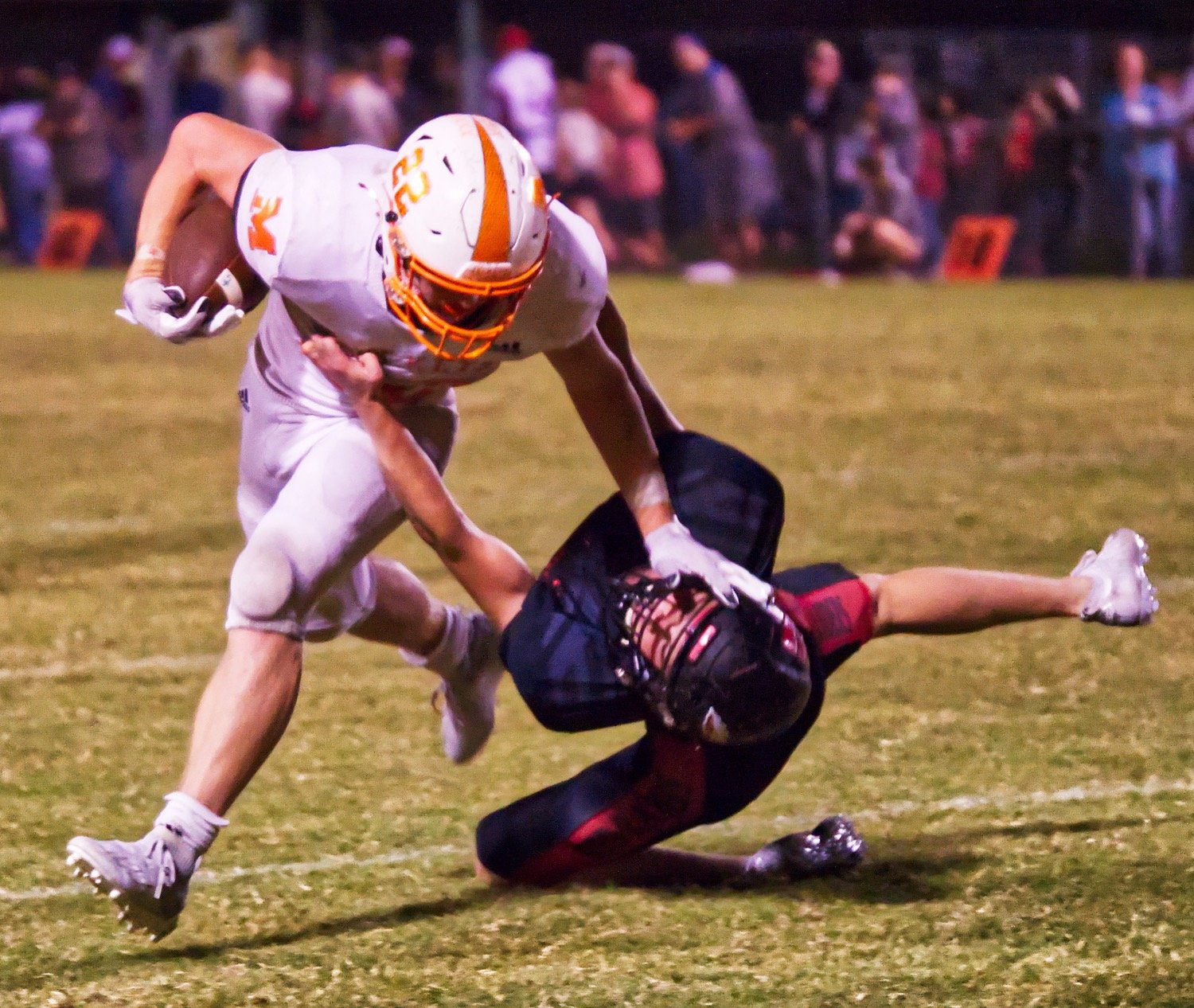 Dawson Pendergrass uses a stiff arm to push his way through and past a Red Raider defender.